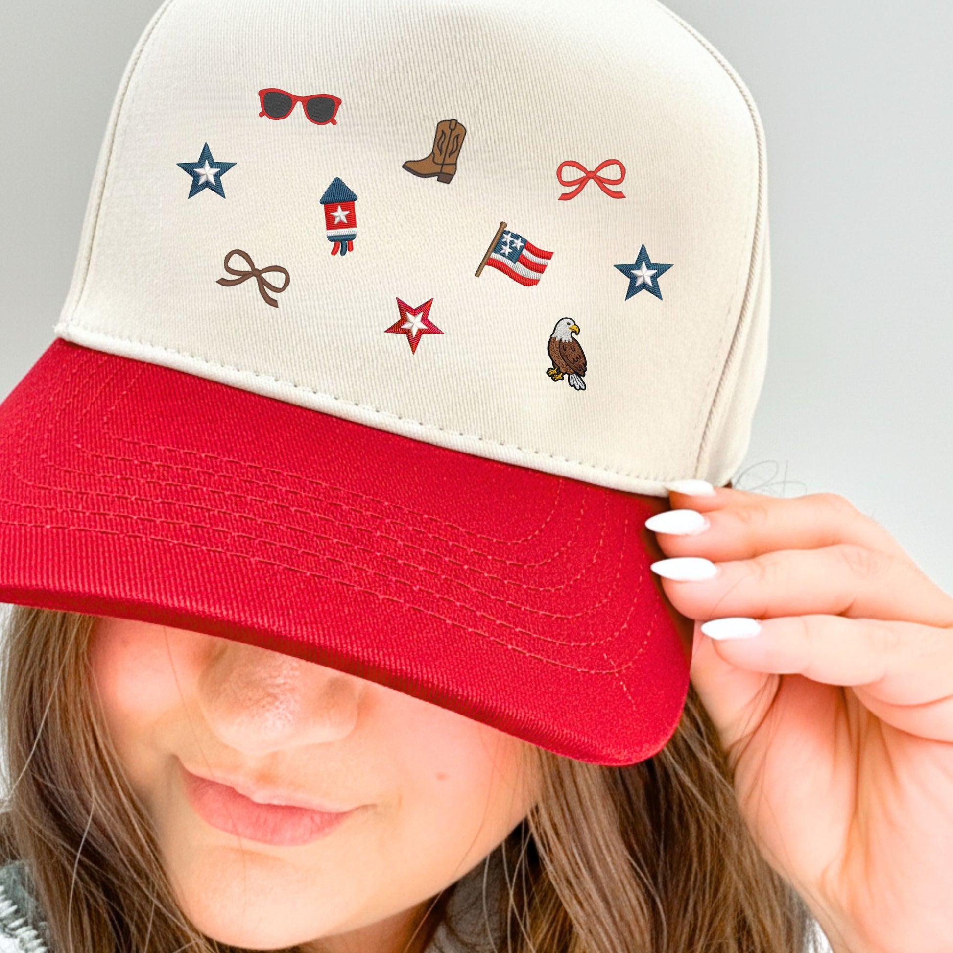 Person wearing a cap with various micro usa embroidered icons including a flag, star, and eagle.