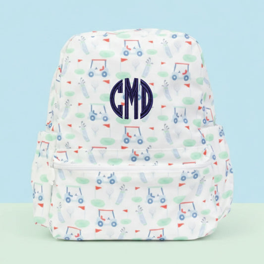 Backpack with golf pattern and a 'CMD' monogram on a light blue background