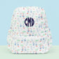 Backpack with golf pattern and a 'CMD' monogram on a light blue background