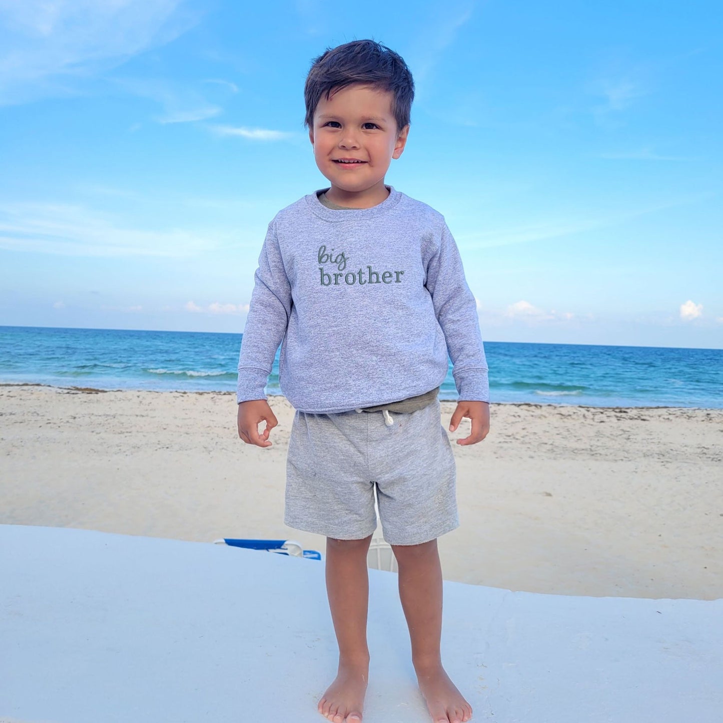 little boy wearing a heather toddler crewneck with custom big brother mixed font embroidered sweatshirt