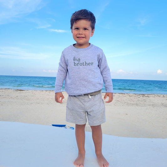 little boy wearing a heather toddler crewneck with custom big brother mixed font embroidered sweatshirt