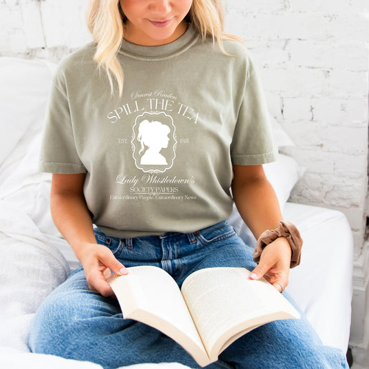 girl wearing a sandstone comfort colors tee with a cute bridgerton inspired spill the tea lady whistledown printed design