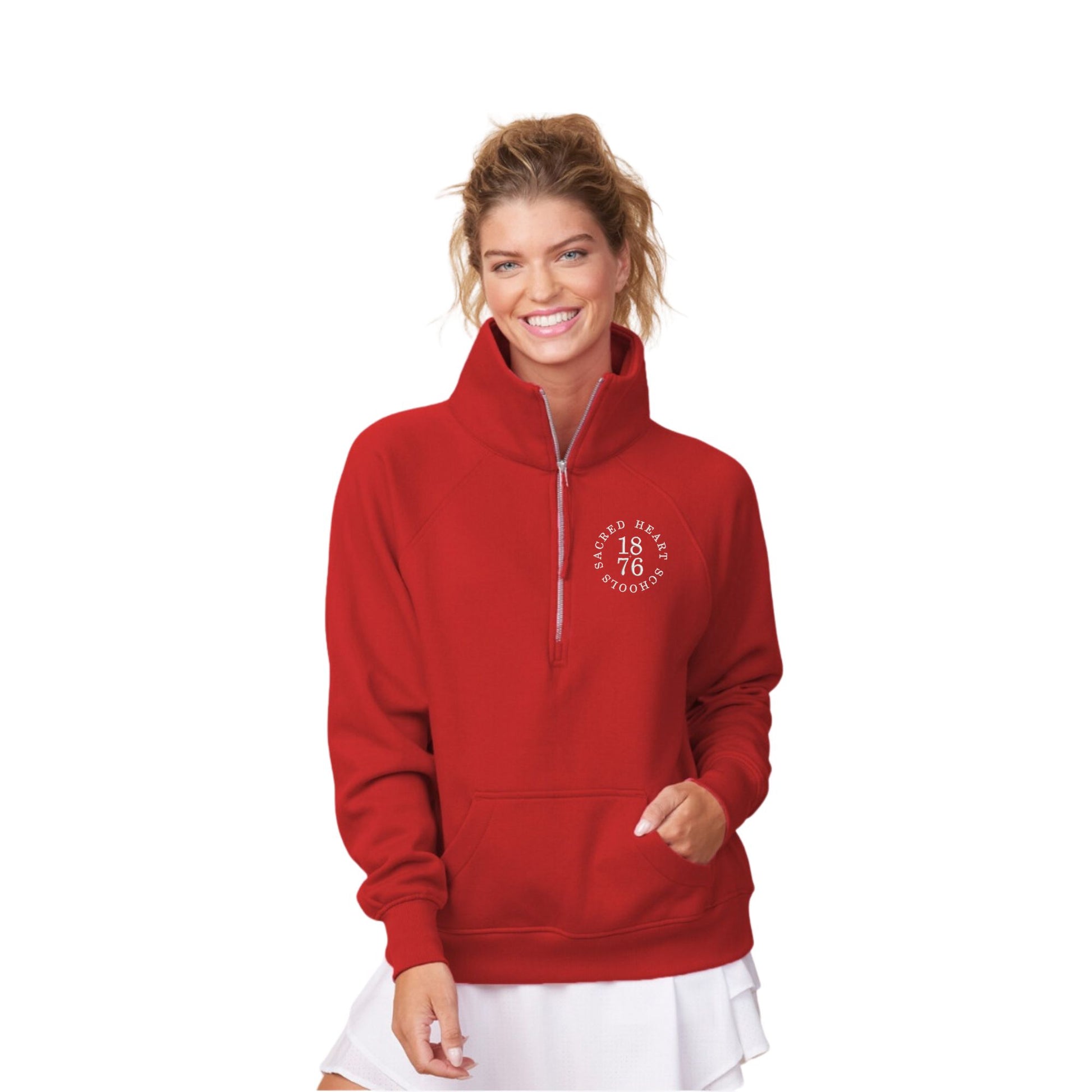 woman wearing a red boxy quarter zip pullover sweatshirt with custom embroidered sacred heart schools logo on the left chest in white thread