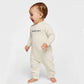 baby wearing a natural heather fleece romper with embroidered baby bro in navy thread on the chest