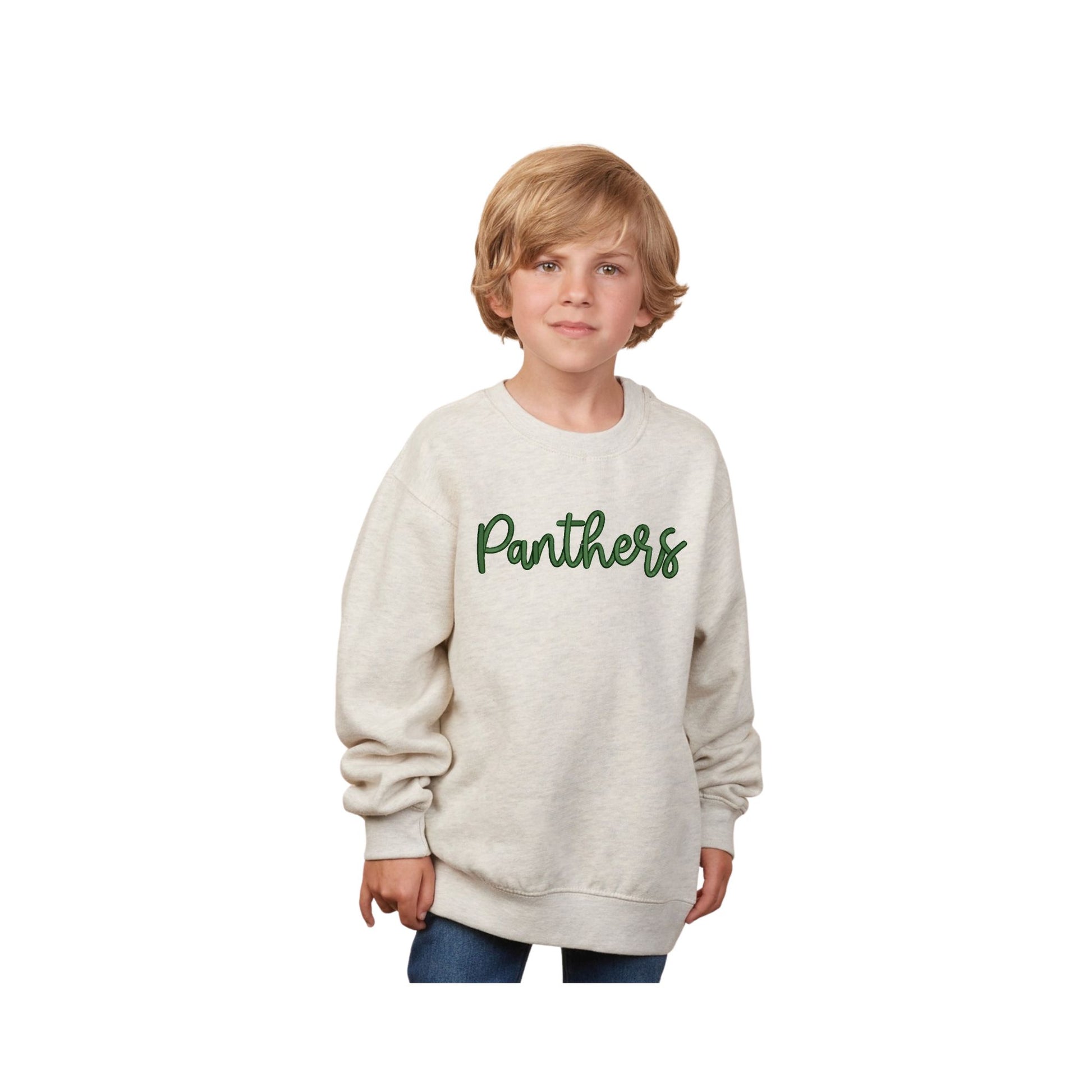 Child wearing a beige sweatshirt with 'Panthers' printed on it against a white background