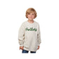 Child wearing a beige sweatshirt with 'Panthers' printed on it against a white background