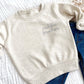 natural heather toddler crew with custom middle brother stitched design on the left chest in french blue thread