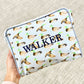 Pouch with duck pattern and 'WALKER' text embroidered held by a hand on a textured surface