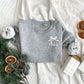 heather grey toddler crewneck with embroidered name and bow on the left chest in white thread.