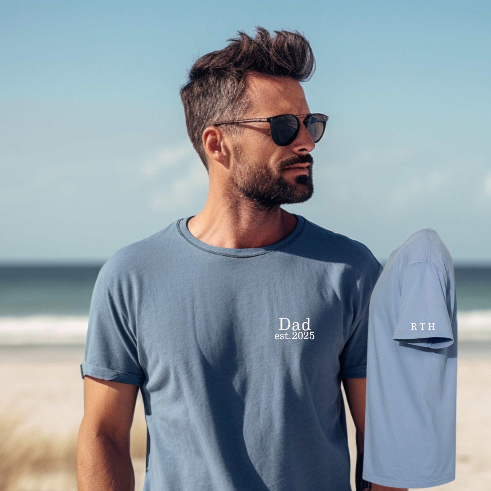 man wearing a large blue jean comfort colors t-shirt with minimal dad and date embroidery on the left chest and three kids' initials embroidered on the left sleeve in white thread