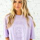 girl wearing an orchid comfort colors t-shirt with custom grow in grace floral frame printed design