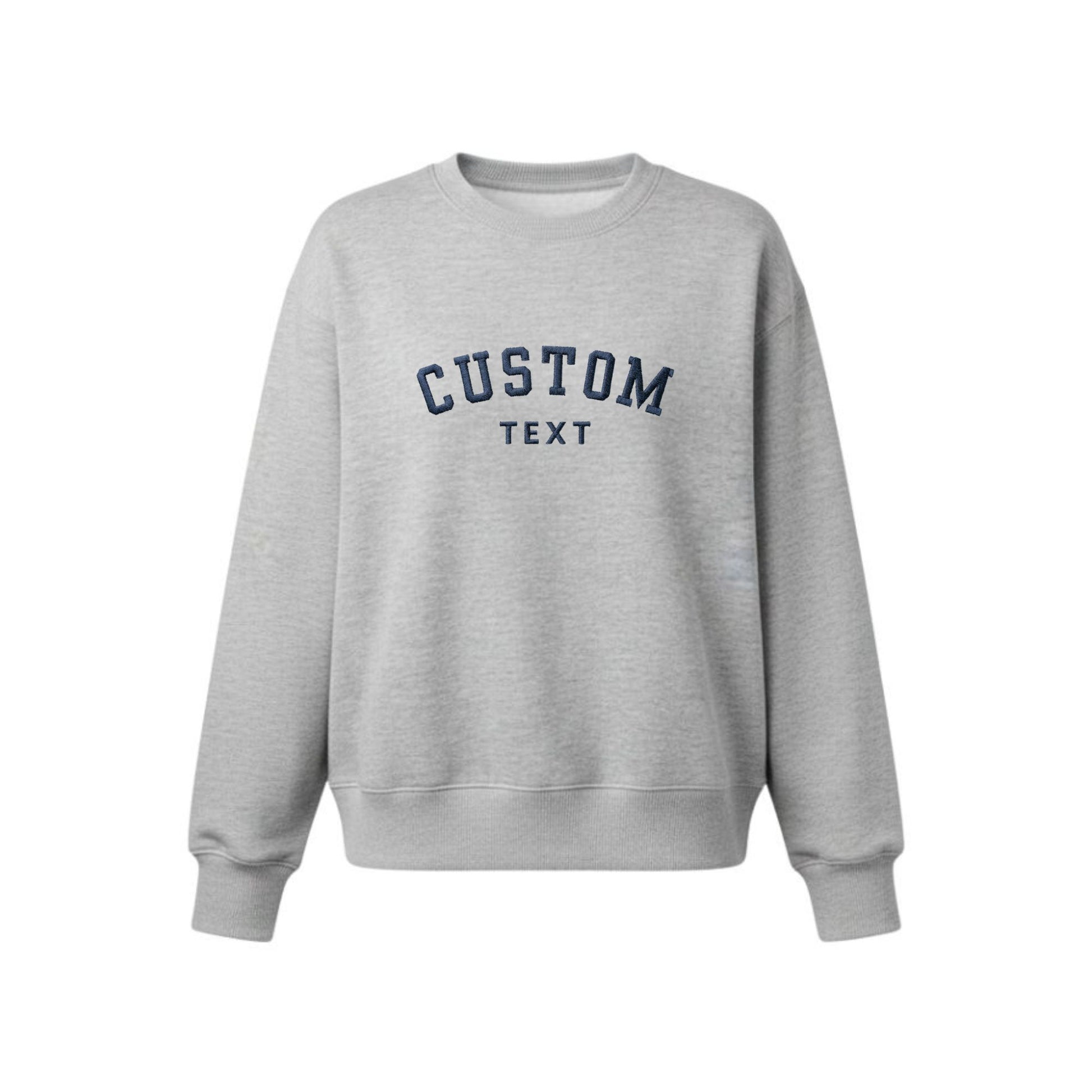 A light heather gray crewneck sweatshirt with 'CUSTOM TEXT' embroidered in navy blue arched lettering on the chest, displayed against a solid white background.