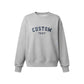 A light heather gray crewneck sweatshirt with 'CUSTOM TEXT' embroidered in navy blue arched lettering on the chest, displayed against a solid white background.