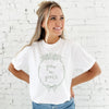 girl wearing a white comfort colors t-shirt with custom grow in grace floral frame printed design