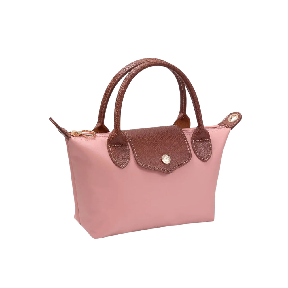 A small pink leather handbag with brown handles and a brown flap closure, shown on a plain white background.