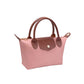 A small pink leather handbag with brown handles and a brown flap closure, shown on a plain white background.