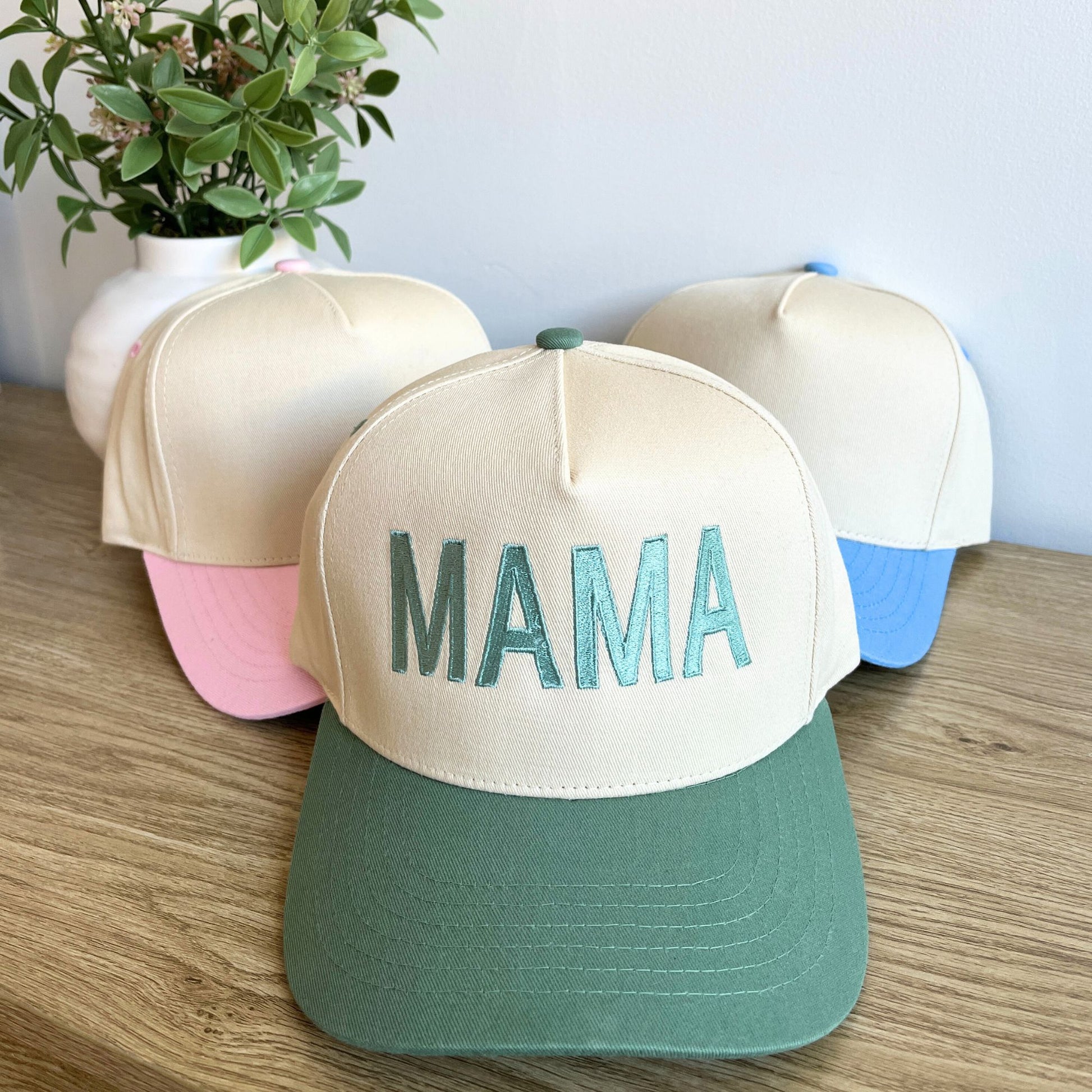 two-trucker hats with custom mama embroidered block font design