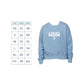 Light blue sweatshirt with 'St. Joseph School Mom' text and size chart on a white background