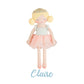 Plush doll with blonde hair and a pink skirt on a white background, labeled 'Claire'.