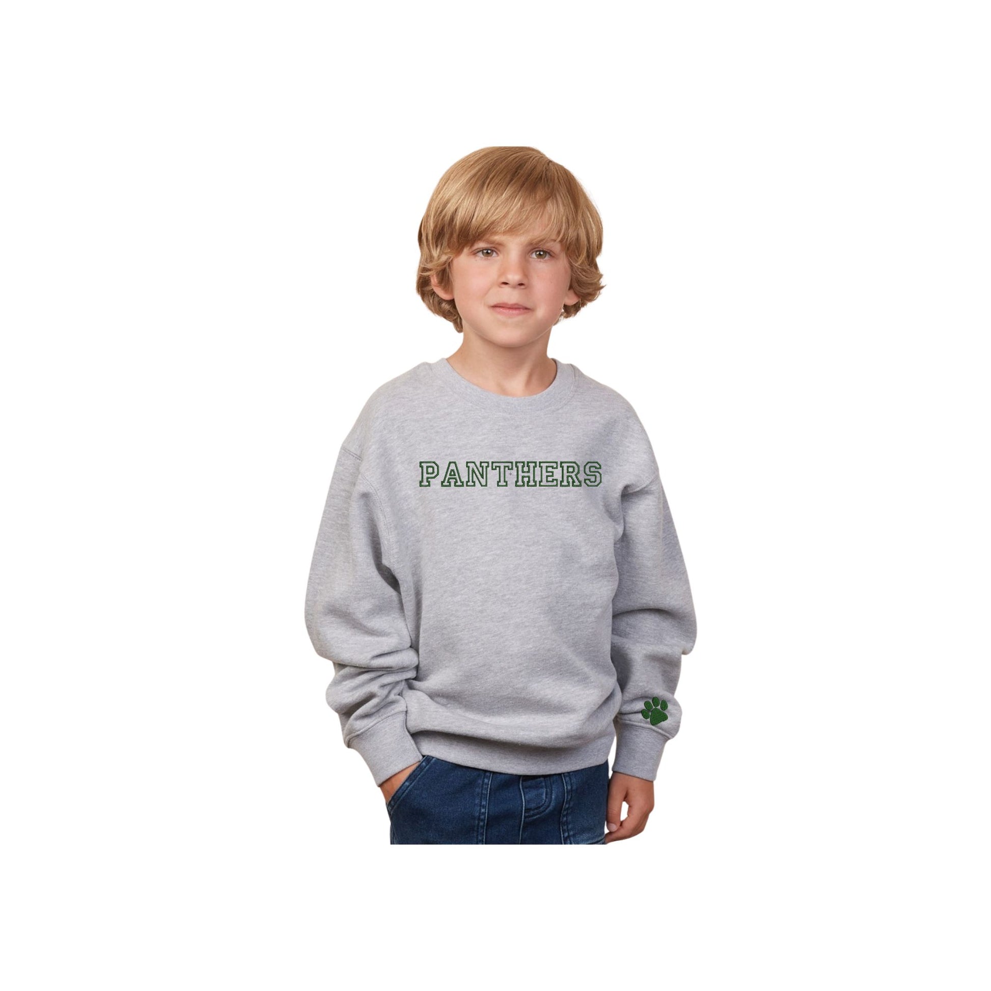 little boy wearing an athletic heather youth sweatshirt with PANTHERS embroidered in an outlined varsity font and green  thread on the center chest and a mini paw print on the left cuff