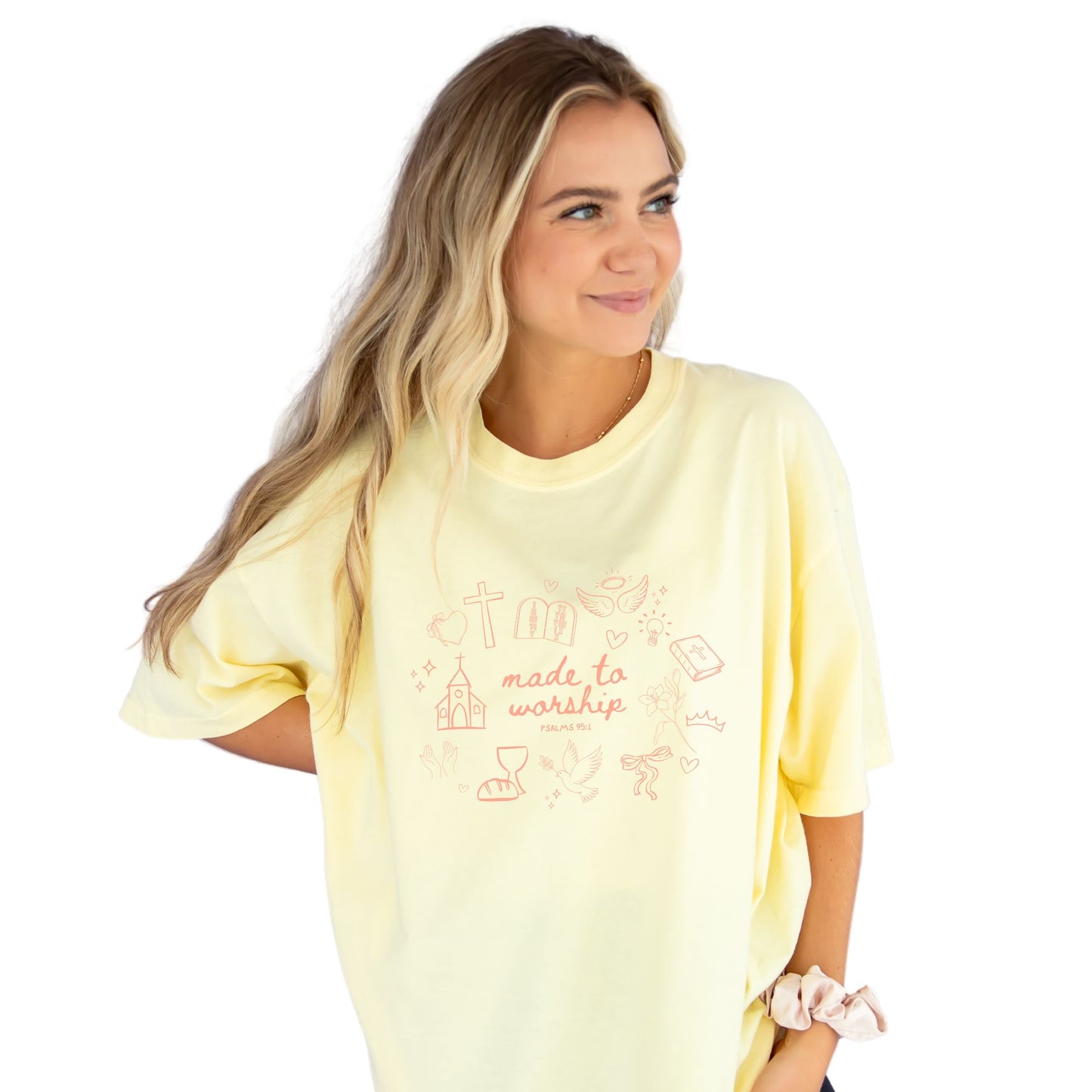 girl wearing a banana comfort colors t-shirt with custom made to worship printed design featuring cute Christian themed drawn icons