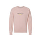 a blush crewneck sweatshirt with a custom name embroidered over an embroidered pencil icon on the center front of the shirt