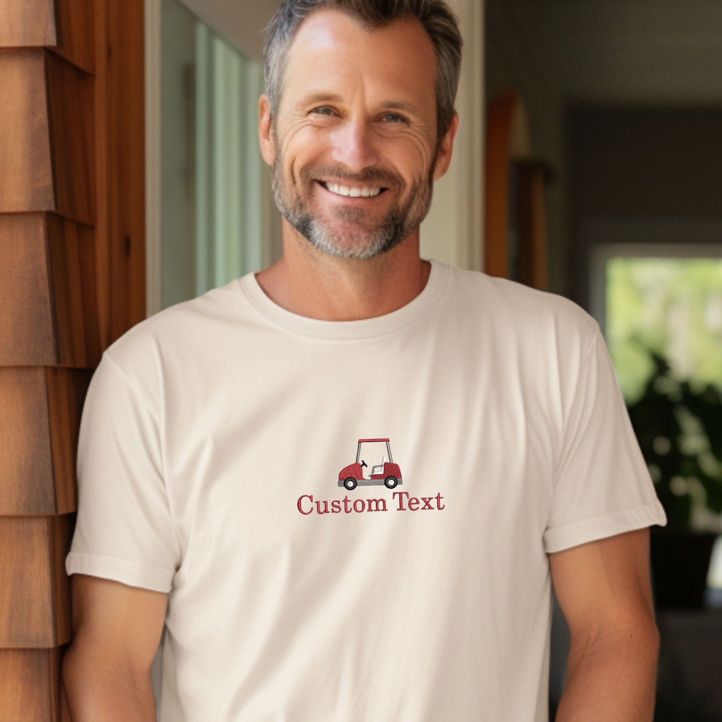 man wearing a custom text golf ball and tee embroidered ivory comfort colors t-shirt