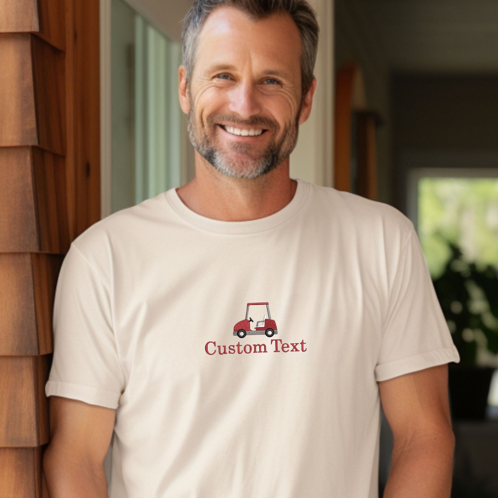 man wearing a custom text golf ball and tee embroidered ivory comfort colors t-shirt