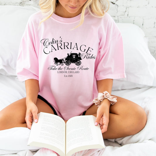 girl reading and wearing an oversized blossom comfort colors tee with a colin's carriage rides printed design
