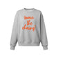 A light gray crewneck sweatshirt featuring the phrase 'move the chains!' printed in a bright orange script font on the front, accompanied by small orange starburst accents.