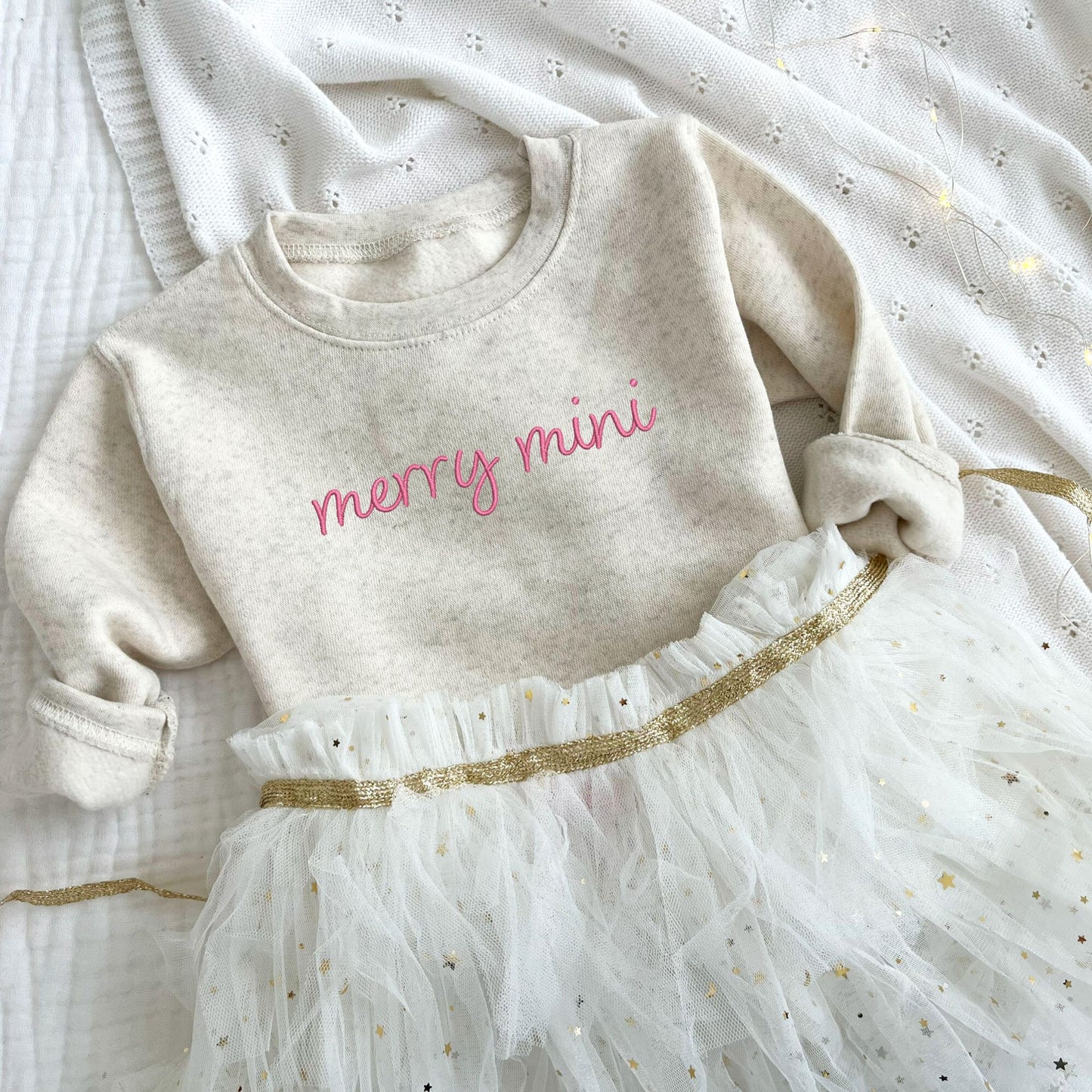 toddler heather oatmeal crewneck sweatshirt with embroidered merry mini design in pink thread across the chest