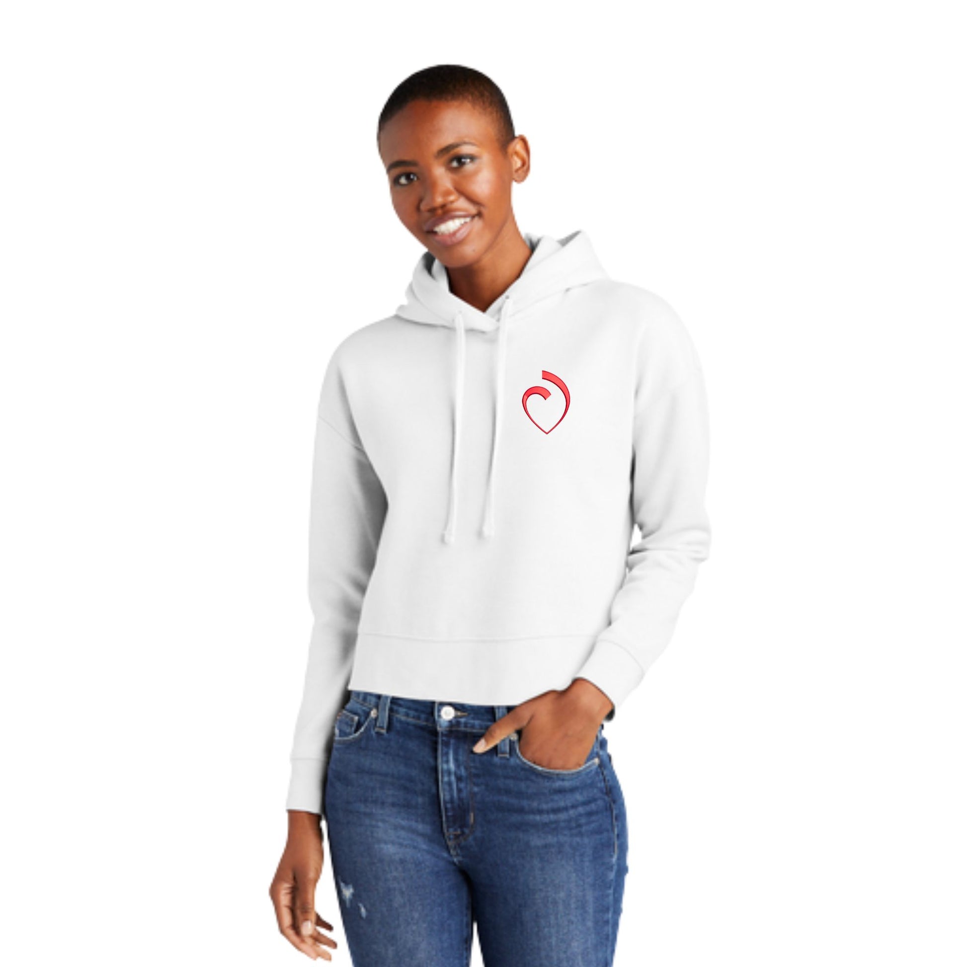 woman wearing a white cropped women's hoodie with custom embroidered sacred heart logo in red thread on the left chest