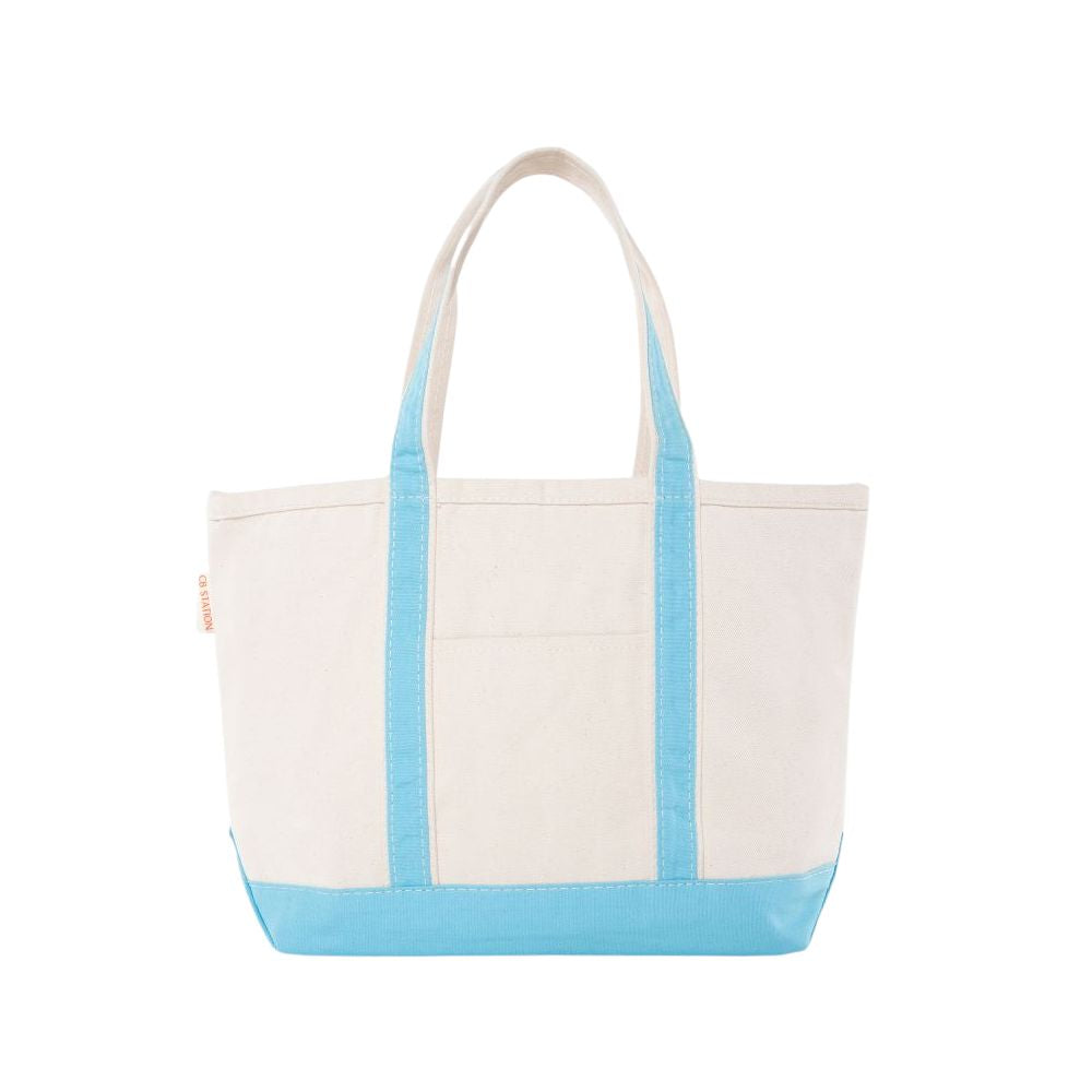 Natural tote bag with baby blue trim on a white background
