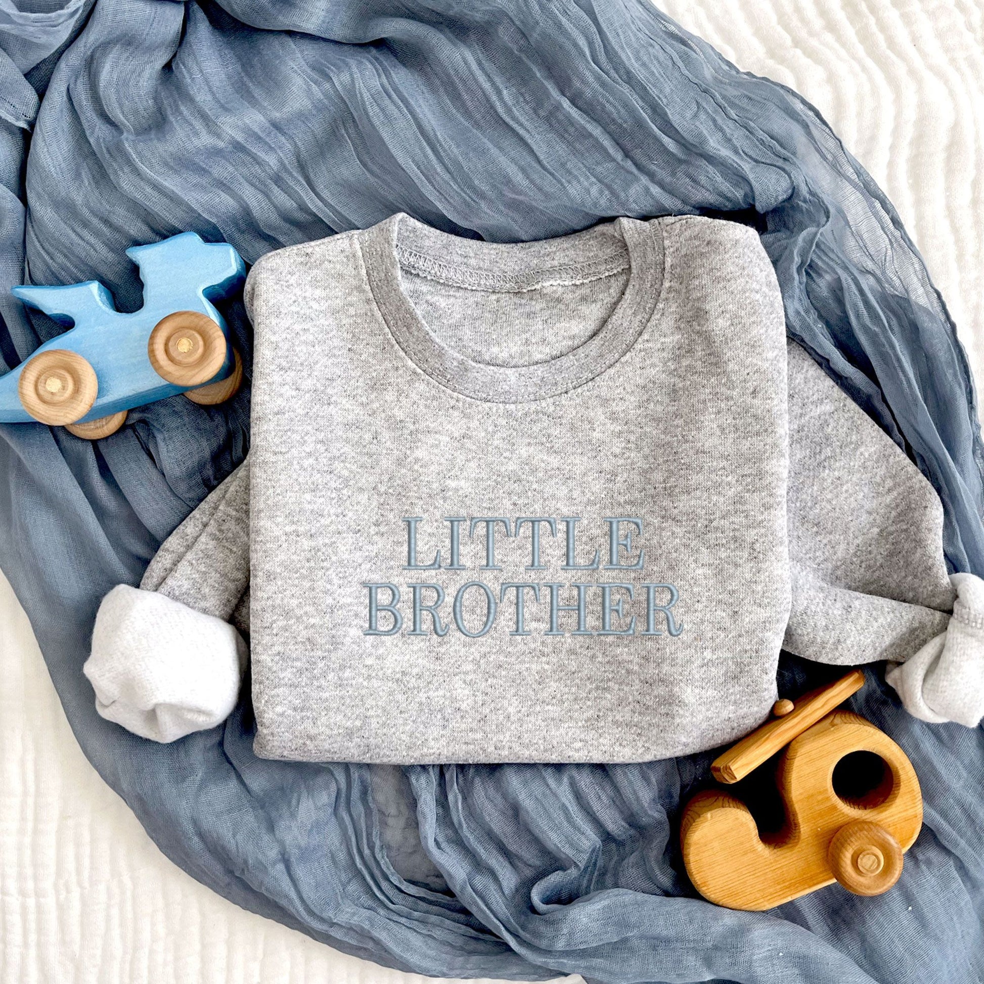 heather toddler crewneck sweatshirt with custom LITTLE BROTHER embroidered design on the center chest in powder blue thread