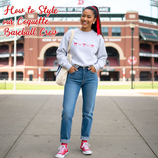 girl with red bow in her hair, wearing an ash crewneck sweatshirt with baseball and bow icons, blue jeans, and red converse