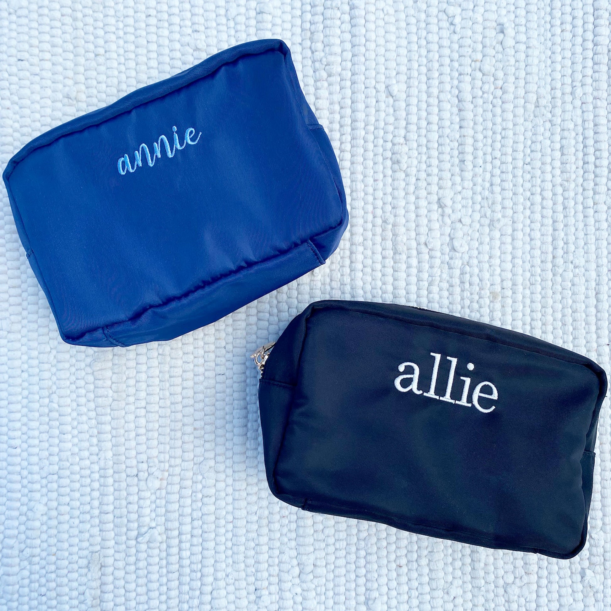 two nylon cosmetic pouches with annie and allie embroidered on them