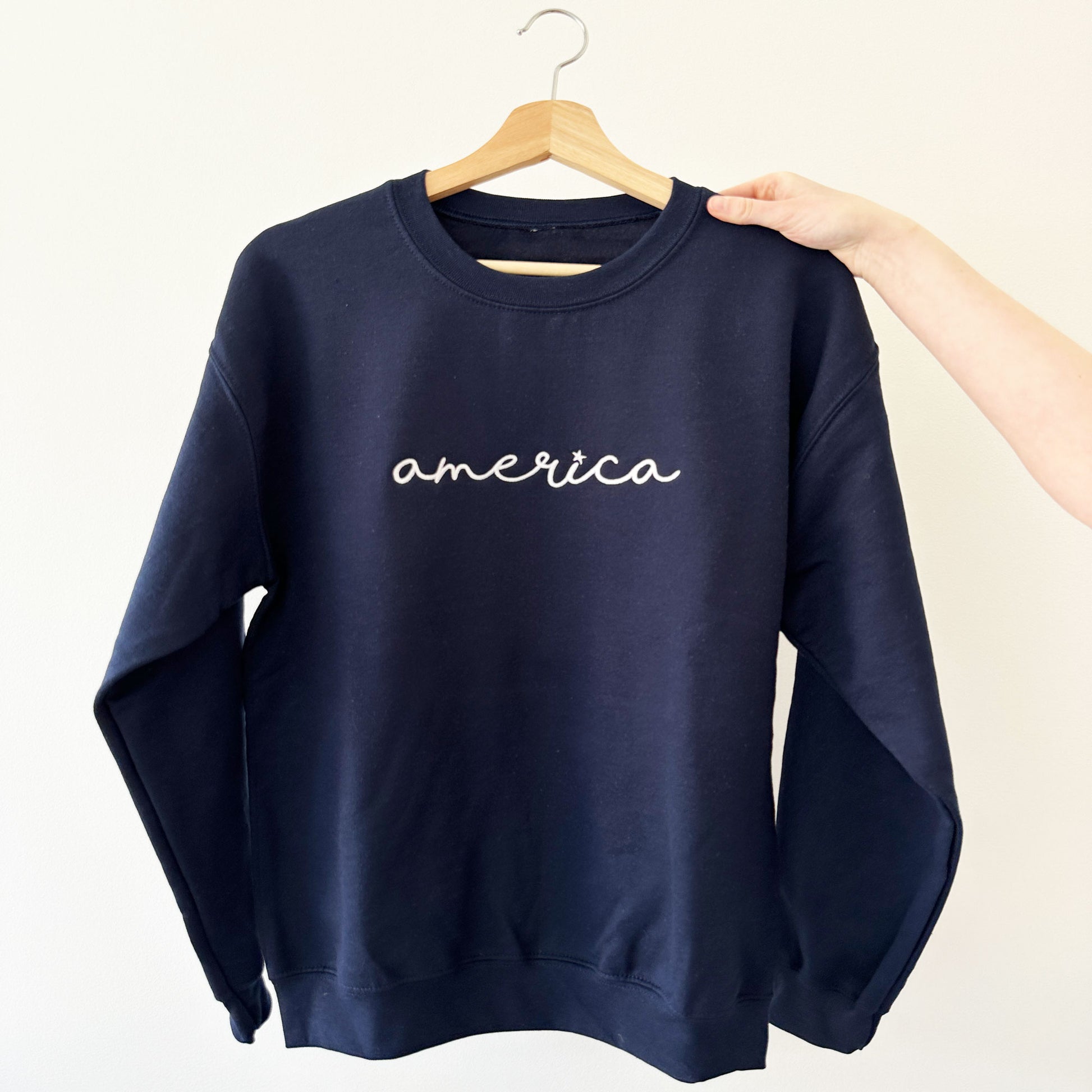 navy sweatshirt with america embroidered design