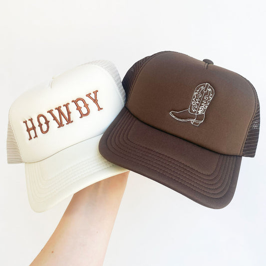 sand and brown trucker hats with embroidered howdy and cowgirl boot designs
