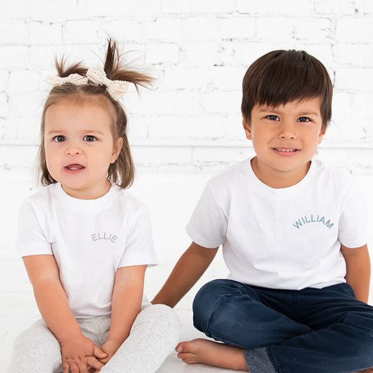 brother and sister wearing matching name embroidered t-shirts