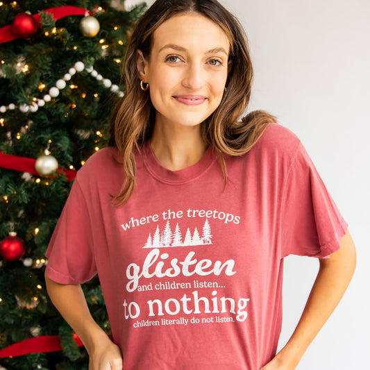woman wearing a crimson tee with a printed where the treetops glisten and children listen to nothing tee
