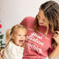 woman and her daughter laughing, woman wearing a short sleeve comfort colors t-shirt with a funny christmas print about children not listening on the front