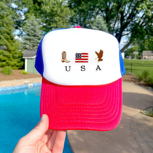 red, white, and blue trucker hat with a patriotic embroidered usa design featuring a cowboy boot, american flag, and bald eagle