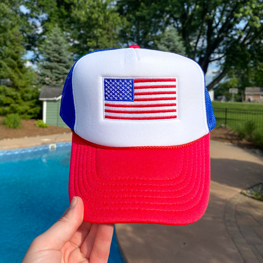 red, white, and blue trucker hat with embroidered usa flag design