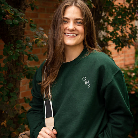 girl wearing a forest green pullover sweatshirt with a custom embroidered monogrammed sweatshirt 