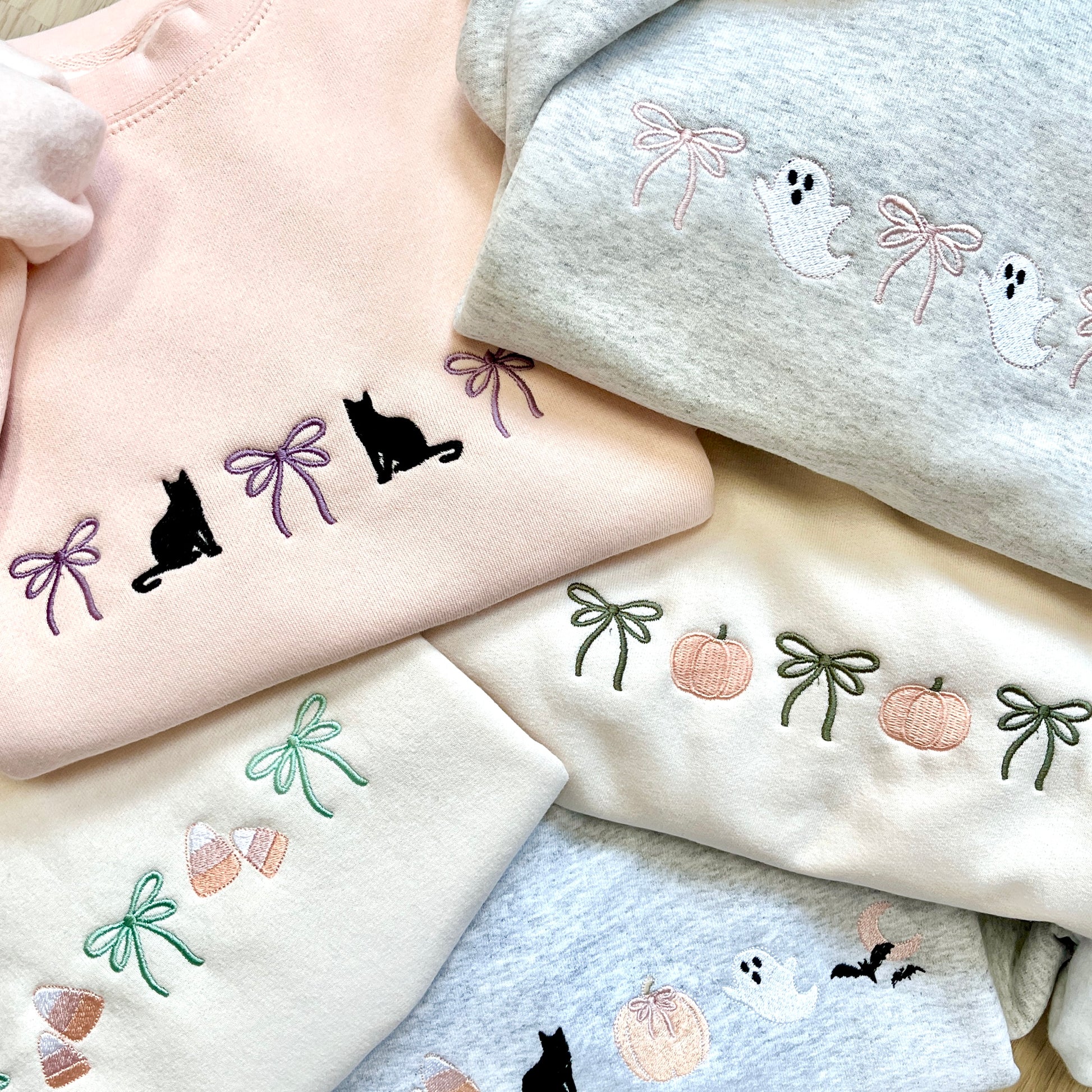 mix of crewneck sweatshirts with cute halloween and bow embroidered icons 