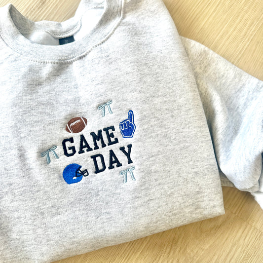 Gray sweatshirt with 'Game Day' text and mini football themed icons embroidered on the center chest 
