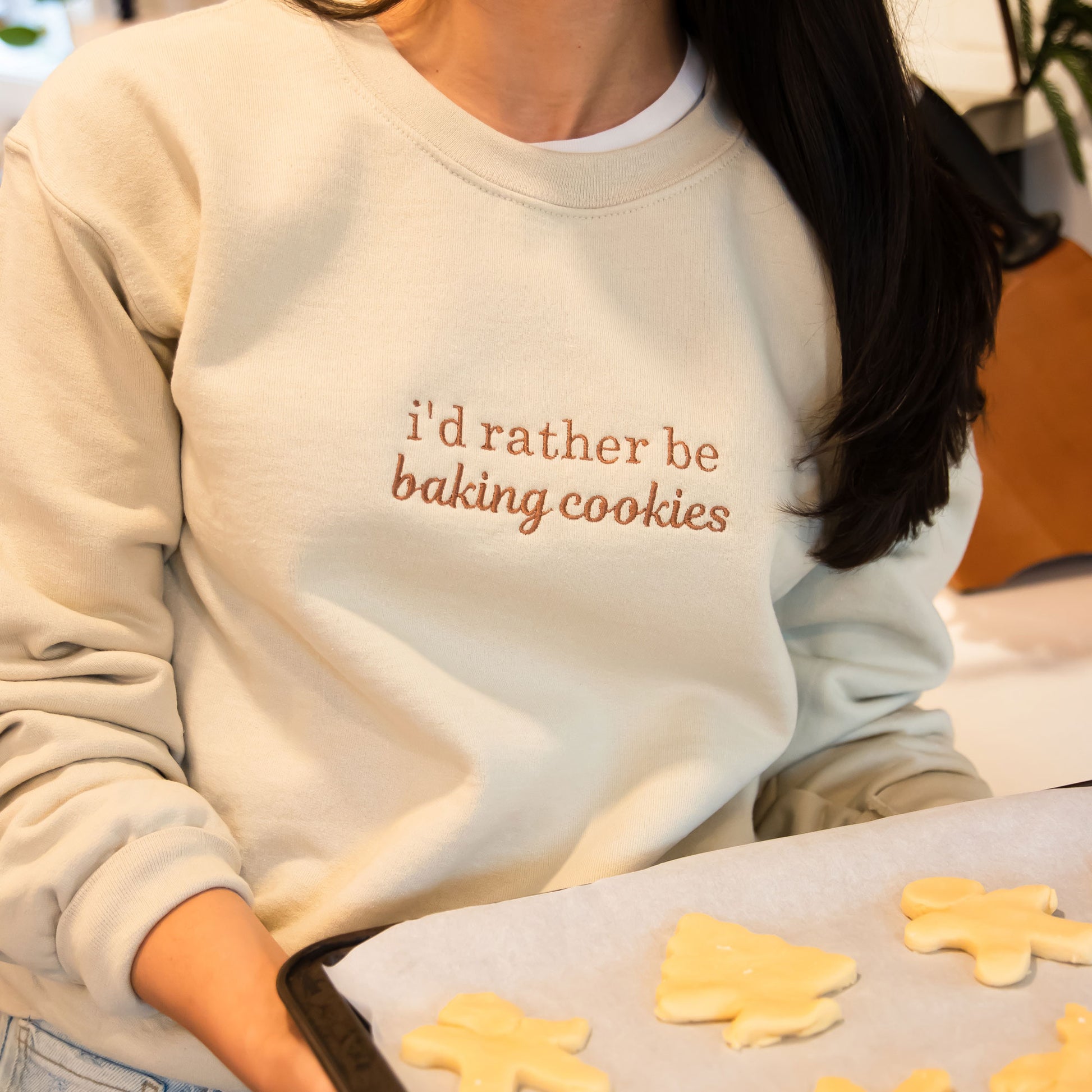 woman baking cookies wearing a i'd rather be baking cookies sweatshirt
