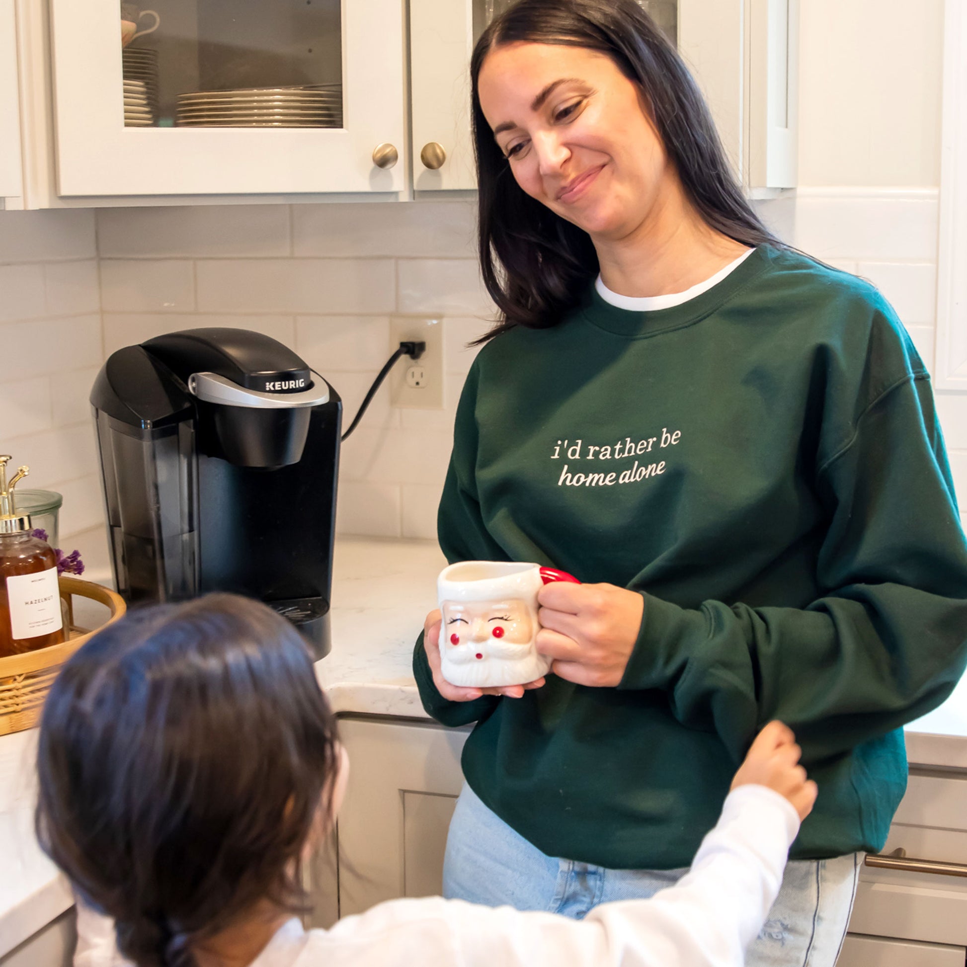 woman wearing a green i'd rather be home alone embroidered crewneck sweatshirt