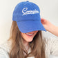 woman wearing a Royal Blue Embroidered baseball hat with Covington design in white thread