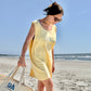 woman wearing a butter comfort colors tank top with 4 seashells and custom hilton head text embroidery design